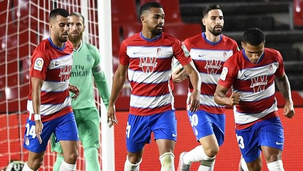 Granada's Darwin Machis, right, celebrates after scoring his side's first goal during the Spanish La Liga soccer match between Granada and Real Madrid at the Los Carmenes stadium in Granada, Spain, Monday, July 13, 2020. (AP Photo/Jose Breton)