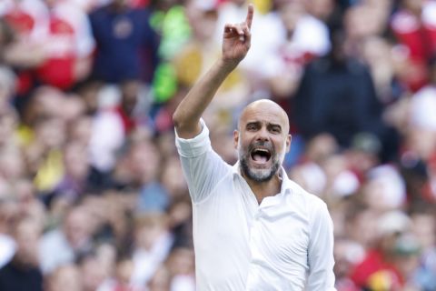 Manchester City's manager Pep Guardiola gives instructions to his players during the English FA Community Shield final soccer match between Arsenal and Manchester City at Wembley Stadium in London, Sunday, Aug. 6, 2023. (AP Photo/David Cliff)