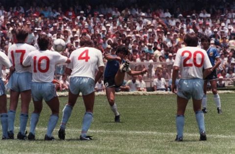 Argentina's Diego Maradona takes a free kick, aiming at the England defensive wall, during their World Cup quarter final match in Mexico City, June 22, 1986. This attempt on goal failed but Argentina went through to the next round with a controversial 2-1 victory. (AP Photo)