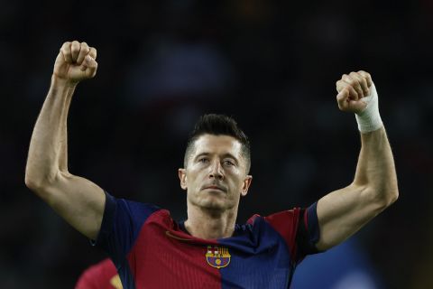 Barcelona's Robert Lewandowski celebrates after scoring the opening goal from the penalty spot during a Spanish La Liga soccer match between Barcelona and Sevilla at the Olimpic Lluis Companys stadium in Barcelona, Spain, Sunday, Oct. 20, 2024. (AP Photo/Joan Monfort)