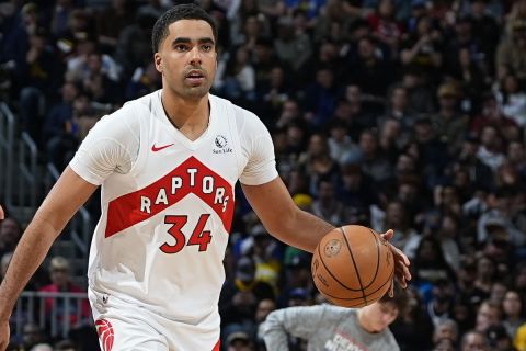 Toronto Raptors center Jontay Porter (34) and Denver Nuggets center Nikola Jokic (15) in the second half of an NBA basketball game Monday, March 11, 2024, in Denver. (AP Photo/David Zalubowski)