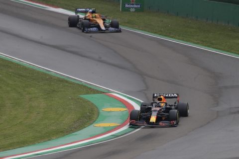 Red Bull driver Max Verstappen of the Netherlands is chased by Mclaren driver Lando Norris of Britain during the Emilia Romagna Formula One Grand Prix, at the Imola racetrack, Italy, Sunday, April 18, 2021. (AP Photo/Luca Bruno)