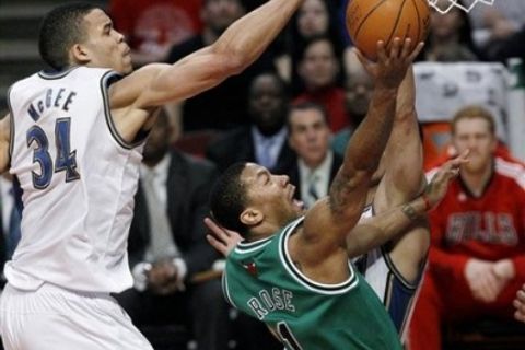 Washington Wizards center JaVale McGee, left, blocks the shot of Chicago Bulls guard Derrick Rose, during the first half of an NBA basketball game, Tuesday, March 15, 2011, in Chicago. (AP Photo/Charles Rex Arbogast)