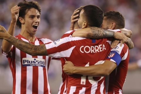 From left, Atletico Madrid forward Joao Felix, Atletico Madrid forward Angel Correa, and Atletico Madrid midfielder Koke celebrate after Correa scored a goal during the first half of an International Champions Cup soccer match against Real Madrid, Friday, July 26, 2019, in East Rutherford, N.J. Atletico Madrid won 7-3. (AP Photo/Steve Luciano)