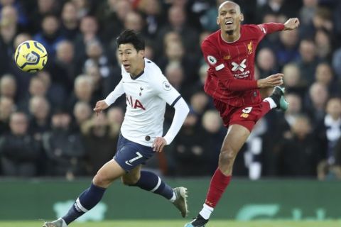 Tottenham's Son Heung-min, left, challenges for the ball with Liverpool's Fabinho during the English Premier League soccer match between Liverpool and Tottenham Hotspur at Anfield stadium in Liverpool, England, Sunday, Oct. 27, 2019. (AP Photo/Jon Super)