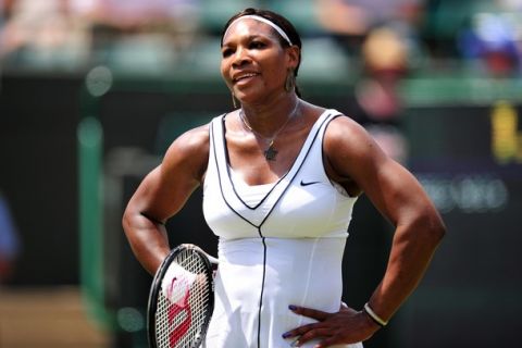 US players Serena Williams reacts after losing a point to French player Marion Bartoli during the women's single at the Wimbledon Tennis Championships at the All England Tennis Club, in southwest London on June 27, 2011.AFP PHOTO / LEON NEAL
RESTRICTED TO EDITORIAL USE (Photo credit should read LEON NEAL/AFP/Getty Images)