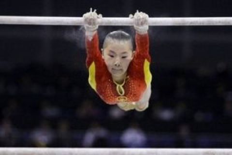 He Kexin of China competes in the women's uneven bars final during the World Gymnastics Championships at the O2 Arena in London, Saturday, Oct. 17, 2009. (AP Photo/Matt Dunham)