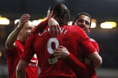 Liverpool's Maxi Rodriguez, right, celebrates with teammates after scoring against Blackburn during their English Premier League soccer match at Ewood Park Stadium, Blackburn, England, Tuesday, April 10, 2012. (AP Photo/Jon Super)