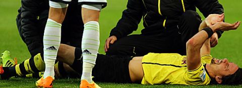 WOLFSBURG, GERMANY - NOVEMBER 09:  Neven Subotic of Dortmund lies injured on the pitch during the Bundesliga match between VfL Wolfsburg and Borussia Dortmund at Volkswagen Arena on November 9, 2013 in Wolfsburg, Germany.  (Photo by Martin Rose/Bongarts/Getty Images)