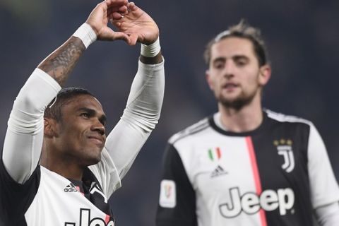 Juventus' Douglas Costa celebrates after scoring his side's fourth goal of the game during the Italian Cup soccer match between Juventus and Udinese, at the Allianz Stadium in Turin, Italy, Wednesday, Jan. 15, 2020. (Fabio Ferrari/LaPress via AP)