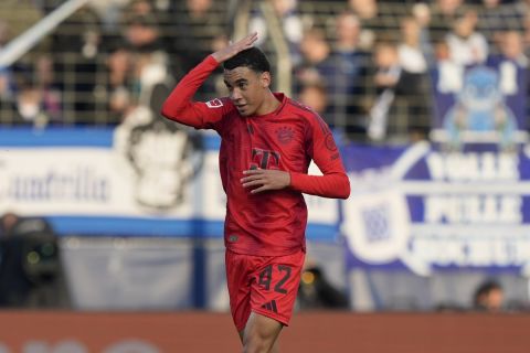 Bayern's Jamal Musiala celebrates after he scored a header during the German Bundesliga soccer match between VfL Bochum and Bayern Munich in Bochum, Germany, Sunday, Oct. 27, 2024. (AP Photo/Martin Meissner)