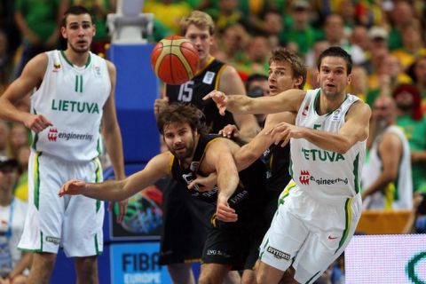 VILNIUS, LITHUANIA - SEPTEMBER 11: Johannes Herber and Heiko Schaffartzik  of Germany defend against Mantas Kalnietis of Lithuaniaduring the EuroBasket 2011 second round group E match between Lithuania and Germany at Siemens Arena on September 11, 2011 in Vilnius, Lithuania. (Photo by Christof Koepsel/Bongarts/Getty Images)