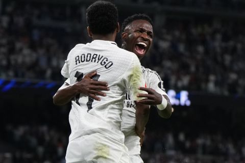 Real Madrid's Rodrygo, left, celebrates with Vinicius Junior after he scored his team's third goal against Espanyol during a Spanish La Liga soccer match at Santiago Bernabeu stadium in Madrid, Spain, Saturday, Sept. 21, 2024. (AP Photo/Manu Fernandez)