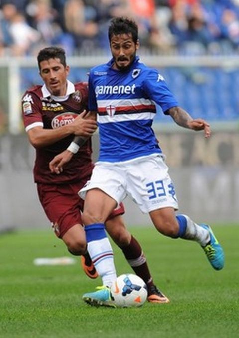 GENOA, ITALY - OCTOBER 06:  Savvas Gentsoglou (R) of UC Sampdoria is challenged by Giuseppe Vives of Torino FC during the Serie A match between UC Sampdoria and Torino FC at Stadio Luigi Ferraris on October 6, 2013 in Genoa, Italy.  (Photo by Valerio Pennicino/Getty Images)