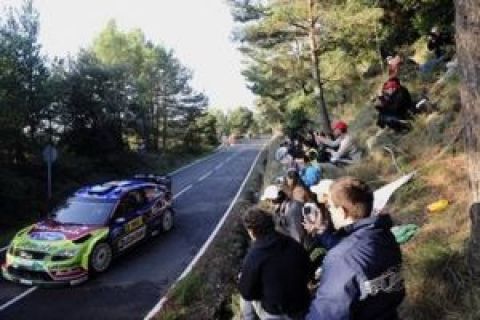 Finland's Jari-Matti Latvala with co-driver Miikka Anttila take a turn in their Ford Focus RS WRC during a first stage of the Rally of Catalonia in L' Albiol, Spain, Friday, Oct. 2, 2009. (AP Photo/Manu Fernandez)