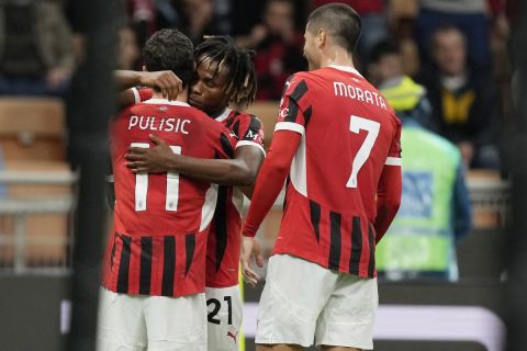 AC Milan's Samuel Chukwueze, second from left, celebrates with Christian Pulisic, left, after scoring the opening goal during the Serie A soccer match between AC Milan and Udinese at the San Siro Stadium, in Milan, Italy, Saturday, Oct. 19, 2024. (AP Photo/Antonio Calanni)