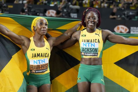 Bronze medalist Shelly-Ann Fraser-Pryce and silver medalist Shericka Jackson, both of Jamaica, from left, pose after the Women's 100-meter final during the World Athletics Championships in Budapest, Hungary, Monday, Aug. 21, 2023. (AP Photo/Matthias Schrader)