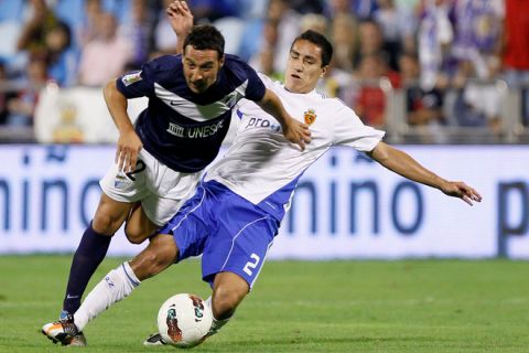 Malaga's midfielder Santiago Cazorla ( L) vies with Zaragoza's Mexican defender Efrain Juarez ( R) during their Spanish League football match, on September 25, 2011 at La Romareda stadium in Zaragoza. AFP PHOTO/CESAR MANSO (Photo credit should read CESAR MANSO/AFP/Getty Images)