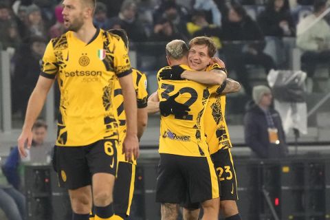 Inter Milan's Nicolo Barella, centre, celebrates after scoring his side's third goal during the Italian Serie A soccer match between Lazio and Inter at Rome's Olympic Stadium, Rome, Italy, Monday, Dec. 16, 2024. (AP Photo/Gregorio Borgia)