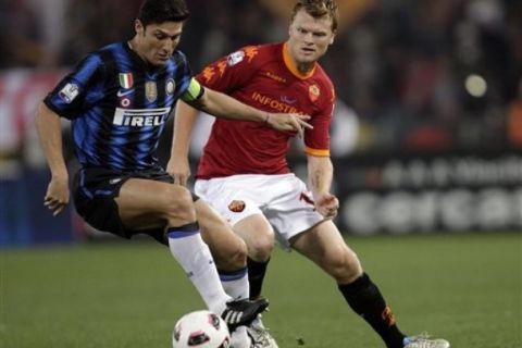 Inter Milan Argentine defender Javier Zanetti, left, and AS Roma defender John Arne Riise, of Norway, go for the ball during their Italian Cup first-leg semifinal match, at Rome's Olympic stadium, Tuesday, April 19, 2011. (AP Photo/Andrew Medichini)