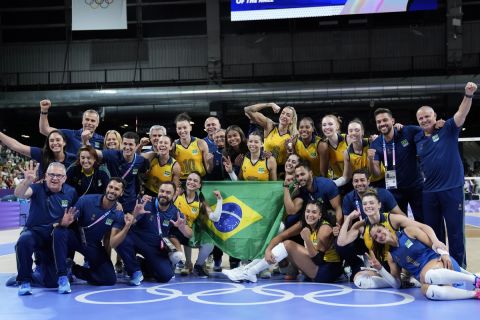 Players from Brazil pose with the olympic rings after winning a bronze medal women's volleyball match against Turkey at the 2024 Summer Olympics, Saturday, Aug. 10, 2024, in Paris, France. (AP Photo/Dolores Ochoa)