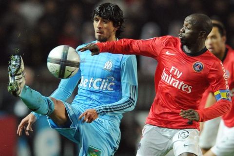 Marseille's midfielder Lucho (L) vies with Paris-Saint-Germain's defender Mamadou Sakho during the French L1 football match Paris vs Marseille, on November 07, 2010 at the Parc des Princes stadium in Paris. Blue, White and Red banner reads : "Let's share our values, red and blue our colours". AFP PHOTO / FRANCK FIFE (Photo credit should read FRANCK FIFE/AFP/Getty Images)