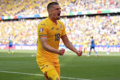 Romania's Razvan Marin celebrates scoring his side's 2nd goal during a Group E match between Romania and Ukraine at the Euro 2024 soccer tournament in Munich, Germany, Monday, June 17, 2024. (AP Photo/Antonio Calanni)