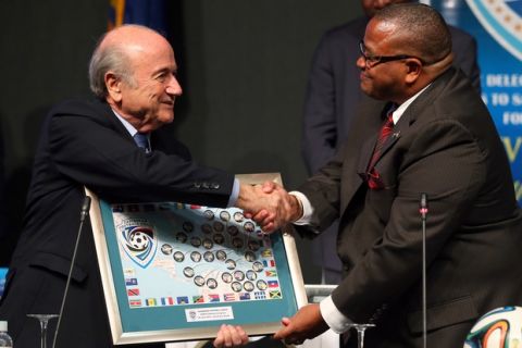 SAO PAULO, BRAZIL - JUNE 09:  FIFA President Joseph S. Blatter receives a gift from Gordon L.A. Derrick, President of the CFU during the CFU confederation congress at Sheraton Sao Paulo WTC hotel on June 9, 2014 in Sao Paulo, Brazil.  (Photo by Alexander Hassenstein - FIFA/FIFA via Getty Images)