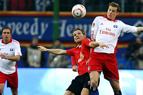 HAMBURG, GERMANY - MARCH 06: Marcell Jansen (R) of Hamburg and Eugen Polanski(L) of Mainz battle for the ball during the Bundesliga match between Hamburger SV and FSV Mainz at Imtech Arena on March 6, 2011 in Hamburg, Germany. (Photo by Martin Rose/Bongarts/GettyImages).