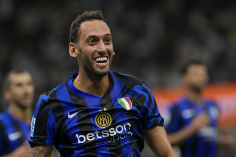 Inter Milan's Hakan Calhanoglu celebrates after scoring his side's second goal during a Serie A soccer match between Inter Milan and Lecce, at the San Siro stadium in Milan, Italy, Saturday, Aug. 24, 2024. (AP Photo/Luca Bruno)