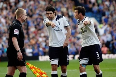 Tottenham Hotspur's Vedran Corluka, center, and Gareth Bale confront the assistant referee after awarding Chelsea's Frank Lampard goal during their English Premier League soccer match at Stamford Bridge stadium in London, Saturday, April 30, 2011. (AP Photo/Simon Dawson) NO INTERNET/MOBILE USAGE WITHOUT FOOTBALL ASSOCIATION PREMIER LEAGUE (FAPL) LICENCE. CALL +44 (0) 20 7864 9121 or EMAIL info@football-datco.com FOR DETAILSball-datco.com FOR DETAILS