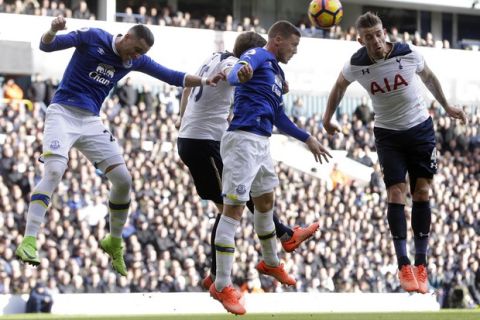 Tottenham Hotspur's Toby Alderweireld, right, heads the ball towards goal during the English Premier League soccer match between Tottenham Hotspur and Everton at White Hart Lane in London, Sunday, March 5, 2017. (AP Photo/Alastair Grant)