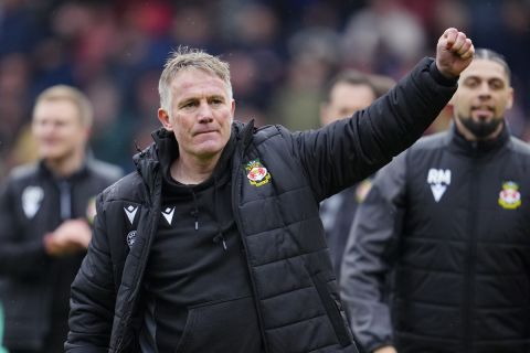 Wrexham manager Phil Parkinson celebrates after the English League Two soccer match between Wrexham and Stockport at the Racecourse Ground Stadium in Wrexham, Wales, Saturday, April 27, 2024. Wrexham AFC got promoted to League One.(AP Photo/Jon Super)