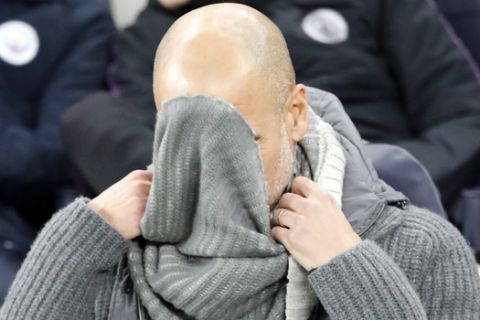 Manchester City coach Pep Guardiola fixes his sweater during the Champions League, round of 8, first-leg soccer match between Tottenham Hotspur and Manchester City at the Tottenham Hotspur stadium in London, Tuesday, April 9, 2019. (AP Photo/Frank Augstein)