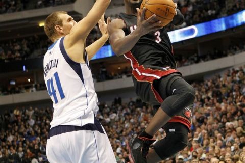 DALLAS - NOVEMBER 27: Dwyane Wade #3 of the Miami Heat drives by Dirk Nowitzki #41 of the Dallas Mavericks on November 27, 2010 at the American Airlines Center in Dallas, Texas. NOTE TO USER: User expressly acknowledges and agrees that, by downloading and or using this Photograph, user is consenting to the terms and conditions of the Getty Images License Agreement.(Photo by Layne Murdoch/Getty Images)