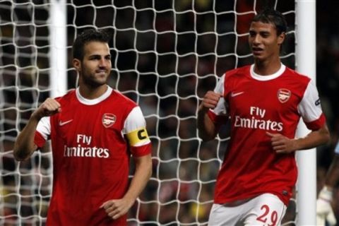 Arsenal's Cesc Fabregas, left, celebrates after scoring from the penalty spot with Marouane Chamakh during their Champions League group H match at the Emirates Stadium, London, Wednesday, Sept 15, 2010.  (AP Photo/Kirsty Wigglesworth) 