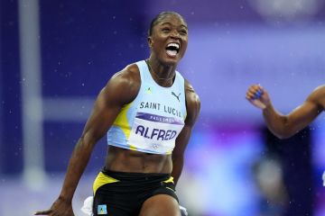 Julien Alfred, of Saint Lucia, celebrates after winning the women's 100-meter final at the 2024 Summer Olympics, Saturday, Aug. 3, 2024, in Saint-Denis, France. (AP Photo/Petr David Josek)