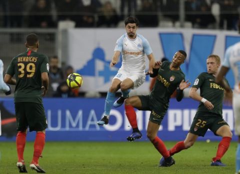 Marseille's Morgan Sanson, center, challenges for the ball with Monaco midfielder Youri Tielemans, second right, during the League One soccer match between Marseille and Monaco at the Velodrome stadium, in Marseille, southern France, Sunday, Jan. 13, 2019. (AP Photo/Claude Paris)