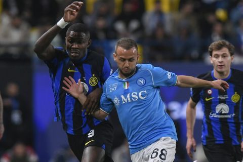 Napoli's Stanislav Lobotka, front right, fights for the ball with Inter Milan's Marcus Thuram, front left, during the Italian Super Cup final soccer match between Inter Milan and Napoli at Al Awwal Park Stadium in Riyadh, Saudi Arabia, Monday, Jan. 22, 2024. (AP Photo)