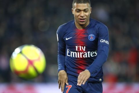 PSG's Kylian Mbappe follows the ball during the French League One soccer match between Paris Saint Germain and Montpellier at the Parc des Princes stadium in Paris, France, Wednesday, Feb. 20, 2019. (AP Photo/Francois Mori)