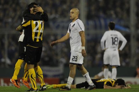 Argentina's Velez Sarsfield forward Santiago Silva (C) reacts while Uruguay's Penarol defender Octavio Rodriguez (#22) and teammate forward Alejandro Martinuccio (L)celebrate their qualifying to the finals of the Copa Libertadores 2011 semifinal second leg football match at Jose Amalfitani stadium in Buenos Aires, Argentina, on June 2, 2011. Penarol lost 2-1 and qualify to play the finals against Brazil's Santos.  AFP PHOTO / Juan Mabromata  (Photo credit should read JUAN MABROMATA/AFP/Getty Images)