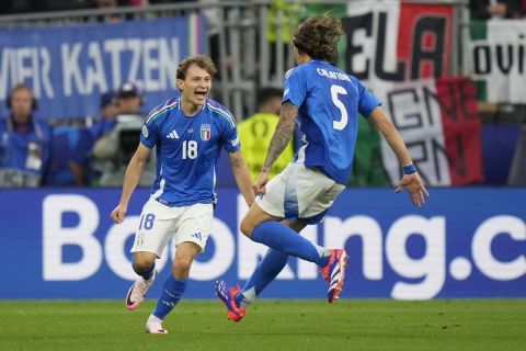 Italy's Nicolo Barella, left, celebrates with his teammate Riccardo Calafiori after scoring his side's second goal during a Group B match between Italy and Albania at the Euro 2024 soccer tournament in Dortmund, Germany, Saturday, June 15, 2024. (AP Photo/Alessandra Tarantino)