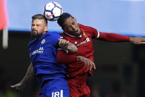 Liverpool's Roberto Firmino, right, jumps for the ball with Chelsea's Olivier Giroud during the English Premier League soccer match between Chelsea and Liverpool at Stamford Bridge stadium in London, Sunday, May 6, 2018. (AP Photo/Kirsty Wigglesworth)