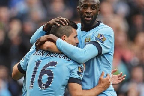 epa04711641 Manchester City's Sergio Kun Aguero (L) celebrates with teammate Yaya Toure(R) after scoring the 2-0 goal during the English Premier League soccer match between Manchester City v West Ham United at the Etihad Stadium in Manchester, Britain, 19 April 2015.  EPA/PETER POWELL DataCo terms and conditions apply 
http://www.epa.eu/files/Terms%20and%20Conditions/DataCo_Terms_and_Conditions.pdf