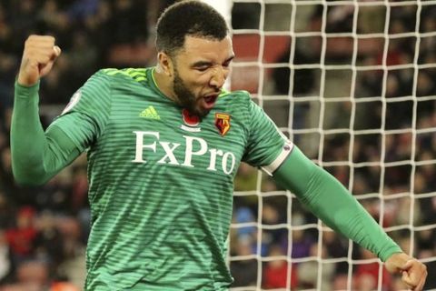 Watford's Troy Deeney celebrates team mate Jose Holebas, not pictured, scoring his side's first goal of the game during the English Premier League soccer match between Southampton and Watford at Saint Marys stadium, Southampton, England. Saturday Nov. 10 2018 (Mark Kerton/PA via AP)