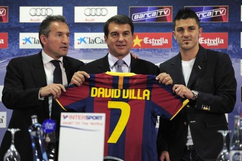 (From L) Barcelona's director of football Txiki Begiristain, President Joan Laporta, new signing David Villa poses with his new shirt during his official presentation after signing with the Catalan giants in Barcelona on May 21, 2010. Spanish international striker David Villa signed a four year with Barcelona for 40 million euros (49.4 million dollars). AFP PHOTO / JOSEP LAGO (Photo credit should read JOSEP LAGO/AFP/Getty Images)