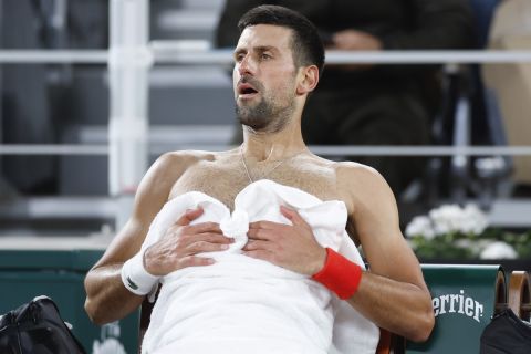 Serbia's Novak Djokovic catches his breath during a changeover in his third round match of the French Open tennis tournament against Italy's Lorenzo Musetti at the Roland Garros stadium in Paris, Sunday, June 2, 2024. (AP Photo/Jean-Francois Badias)