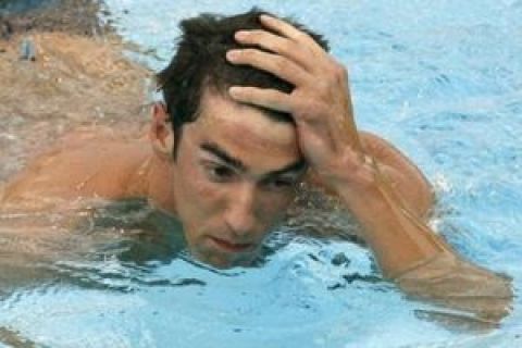 ** RECROPPED VERSION ** Michael Phelps of the United States reacts after completing a Men's 200m Butterfly semifinal, at the FINA Swimming World Championships, in Rome, Tuesday, July 28, 2009. (AP Photo/Alessandra Tarantino)