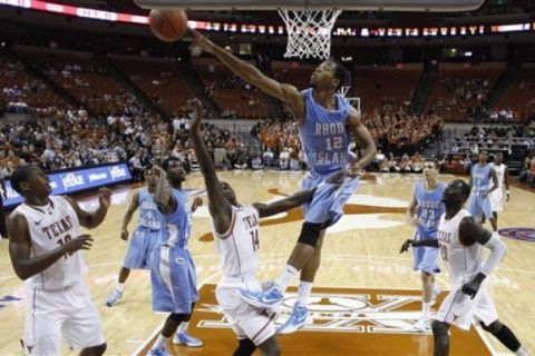 Rhode Island's Orion Outerbridge (12) blocks a shot by Texas' J'Covan Brown (14) during the second half of an NCAA college basketball game Tuesday, Nov. 15, 2011, in Austin, Texas. Texas won 100-90. (AP Photo/Eric Gay)