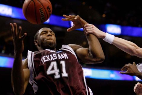 Philadelphia - BYU vs. Texas A&M college basketball, first round NCAA Division I Men's Basketball Championship at the Wachovia Center Thursday March 19, 2009. 
Brigham Young guard Lee Cummard (30) grabs Texas A&M's Chinemelu Elonu (41) 